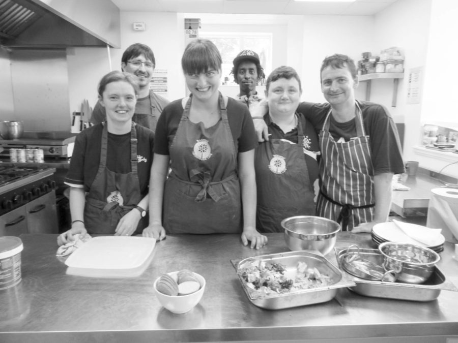 Kitchen volunteers at Bridgend Farmhouse, Edinburgh. Standing in front of a stainless steel worktop.