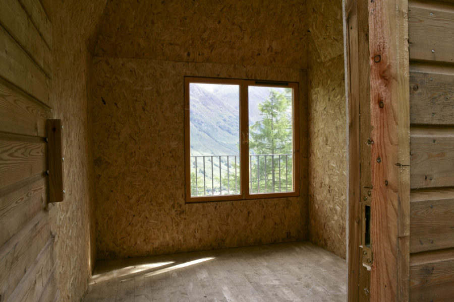 Interior view of Outlandia Field Station cabin. Looking through to window with view across glen.