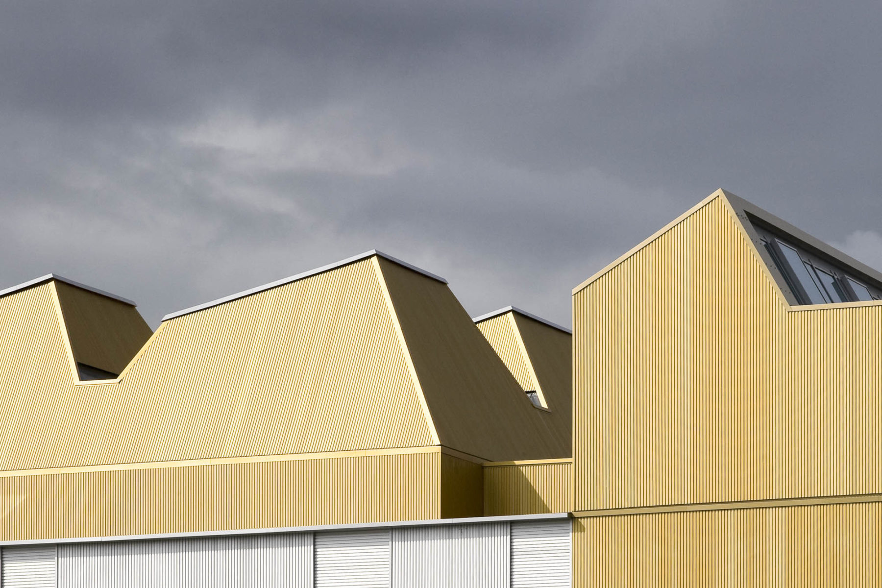 Scottish Ballet, Glasgow. Golden, trapezoid roof forms. Malcolm Fraser Architects