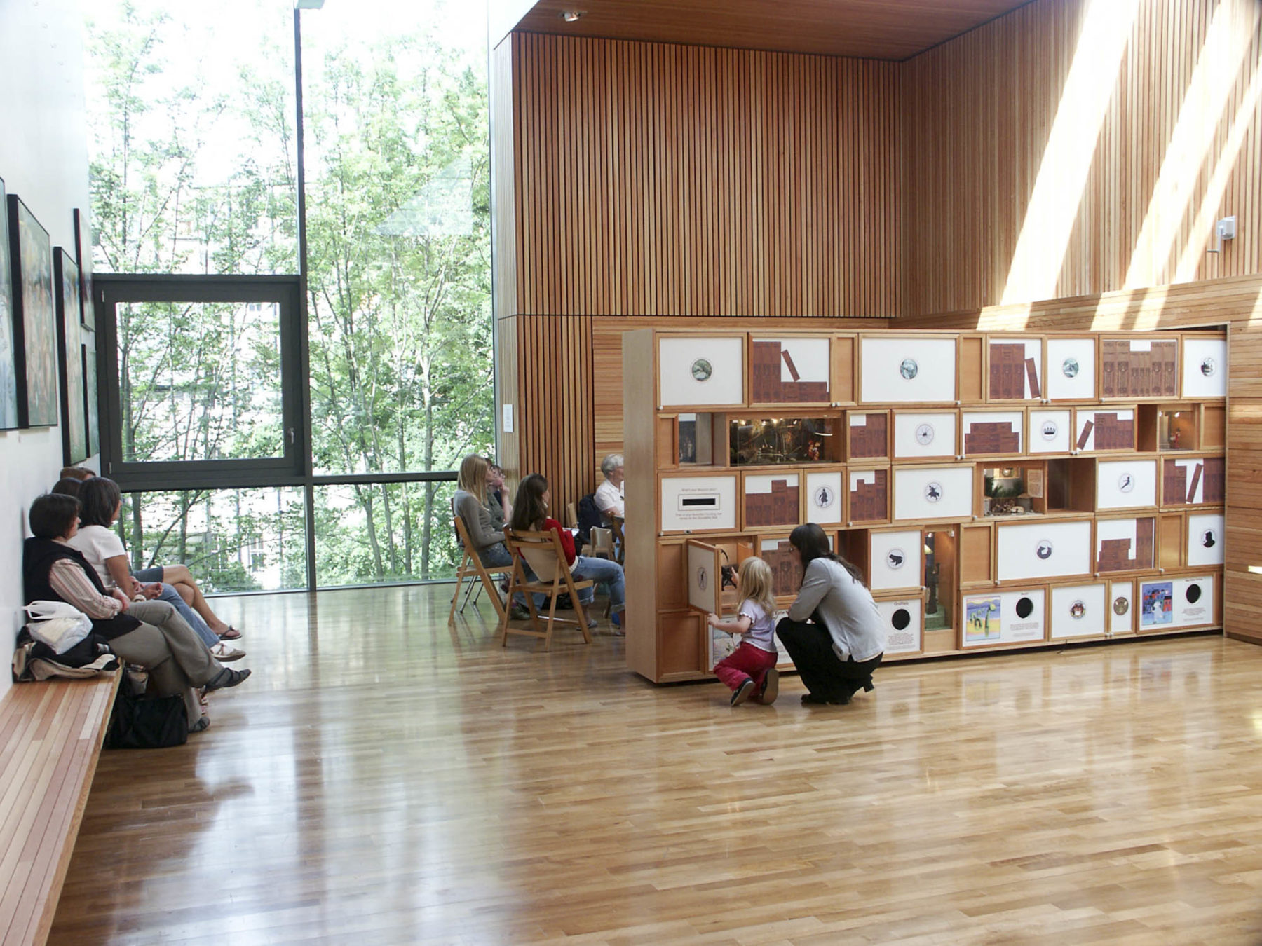 Interior of the Scottish Storytelling Centre looking through the ground floor space to the garden. Pull out shelving creates a divider for the space